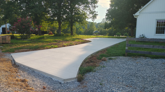 JT Contracting Concrete work - Concrete driveway and parking area with walkway to patio