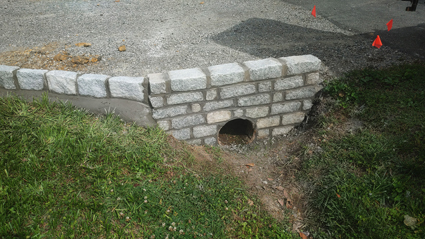 Damaged brick culvert wall needing repair