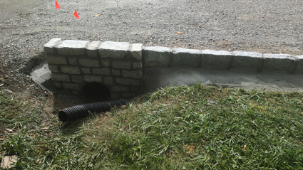 Damaged brick culvert wall needing repair