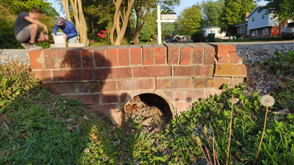 Damaged brick culvert wall needing repair